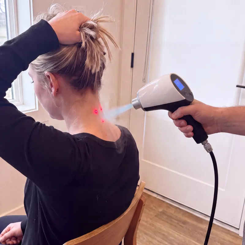 Neck session with red targeting dots on the skin